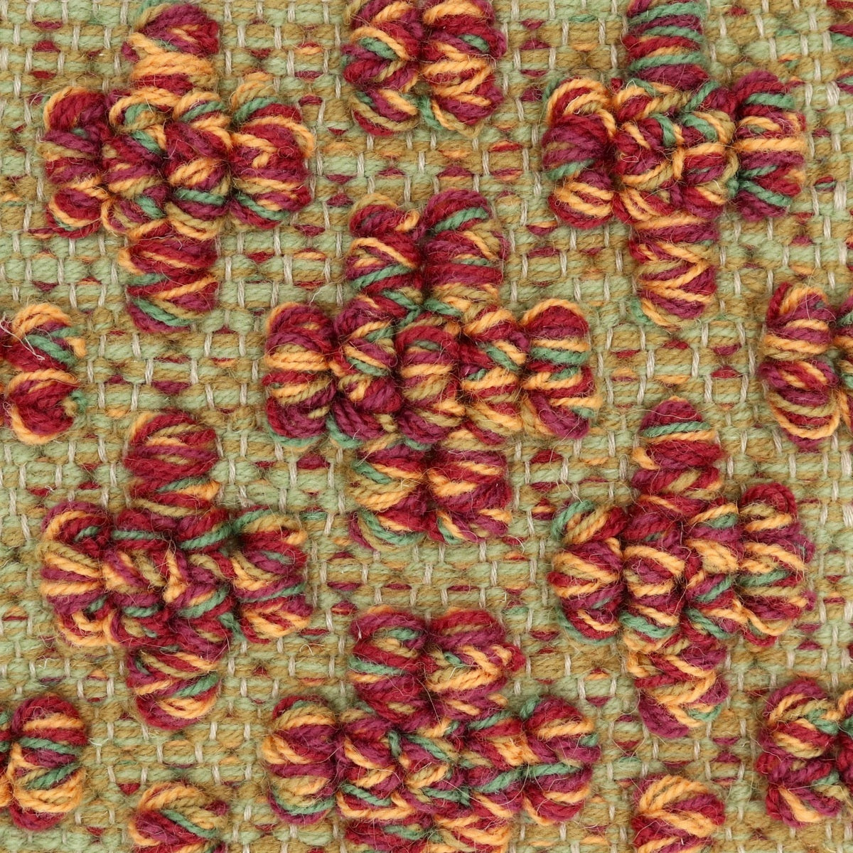 <p>Mini Flower in Bouclé, base green mix 4015, 6004, cross-bouclé mix of 7004, 6037, 6004, 6007, 4006 on the natural yarn</p>